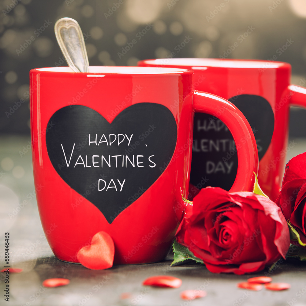 Valentines Day concept with Red Cups and roses on a Wooden Background