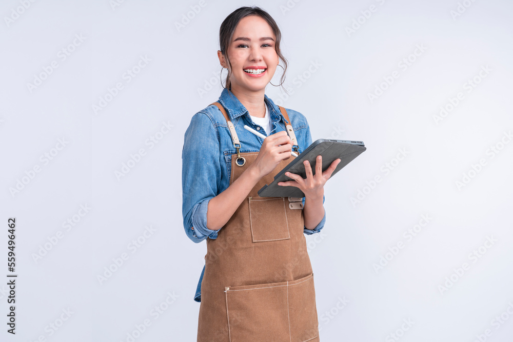 young smiling welcome asian female woman business owner wear apron hand holding tablet ready for you