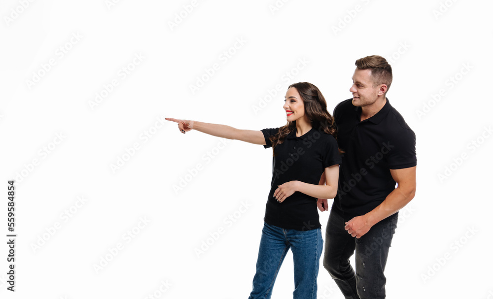 Cheerful emotional couple at isolated background. Young romantic couple posing on white.