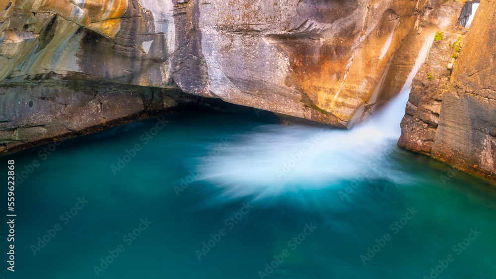 Waterfall and rocks. Long exposure photography. Waterfall and lake. Natural background and wallpaper