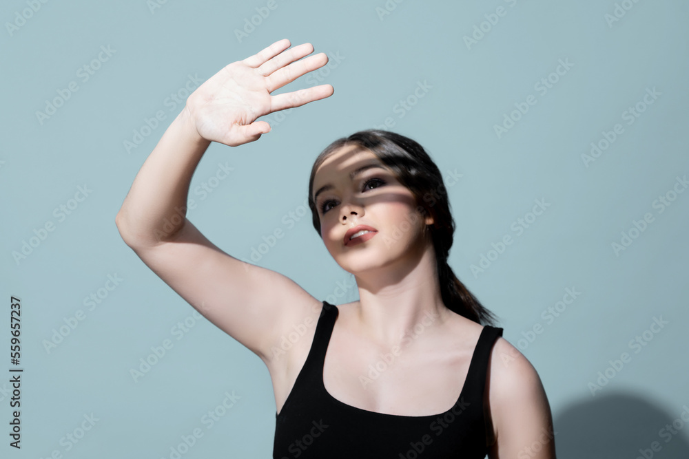 Young charming caucasian teenager girl with clean and fresh skin posing pointing fingers on empty ba