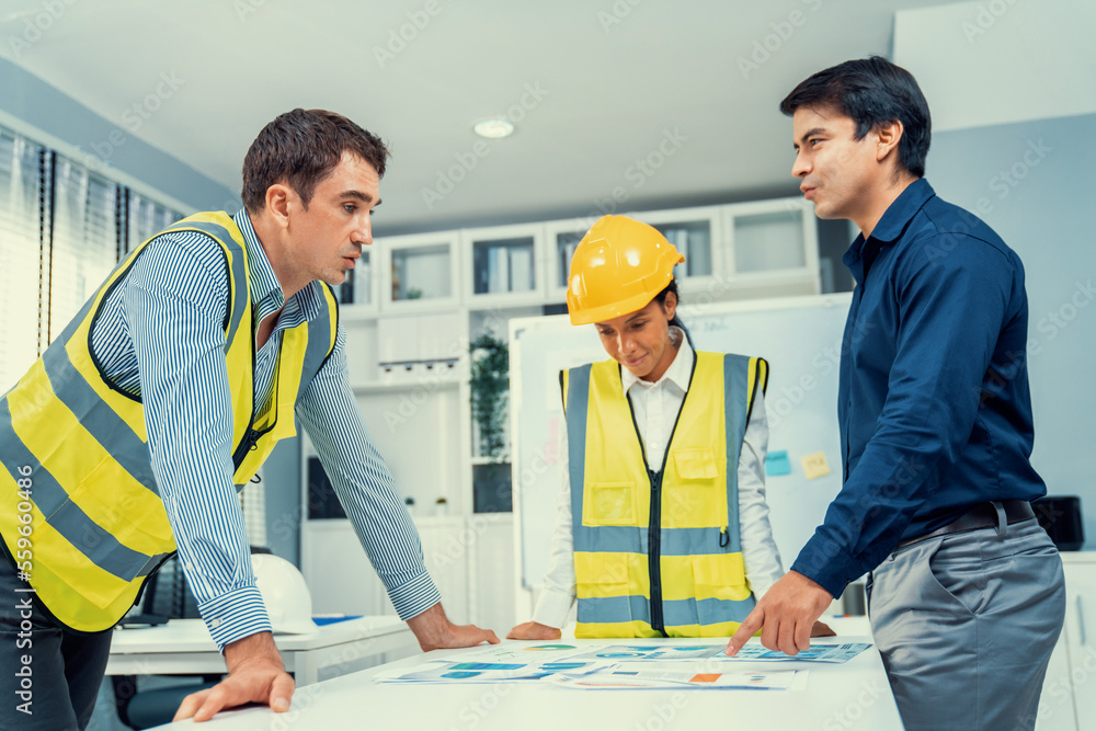 A group of competent engineers and employer discuss plans in the office. Architectural investor, bus