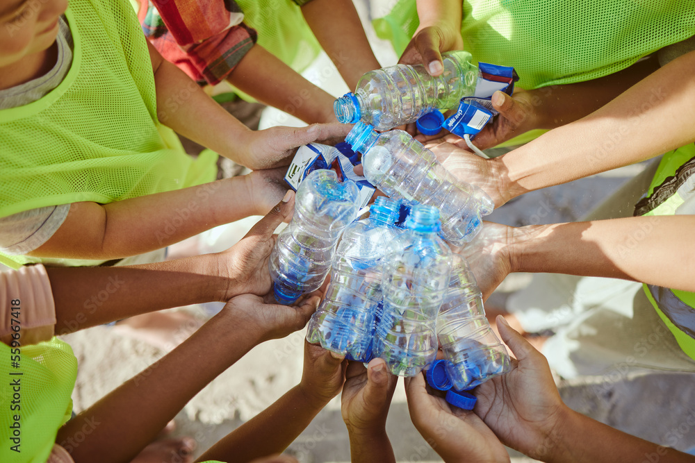 Children, hands and plastic bottles in beach waste management, community service or climate change v