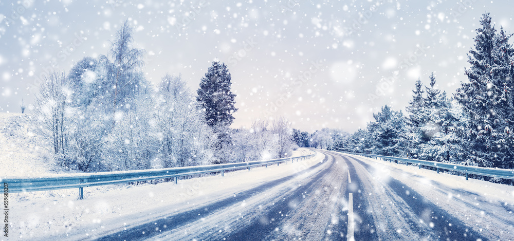 Snowfall on the curvy highway in winter natural park.