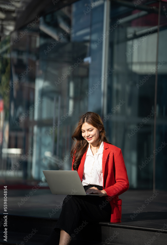 Asian business woman with computer laptop pc in office district.