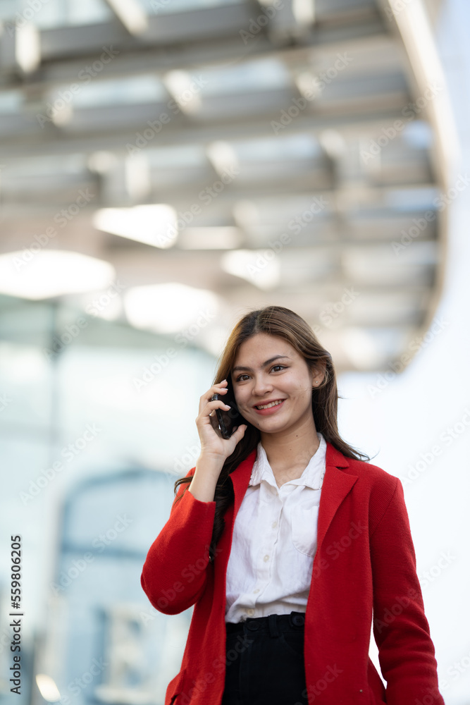 Young asian businesswoman using smart phone in office..