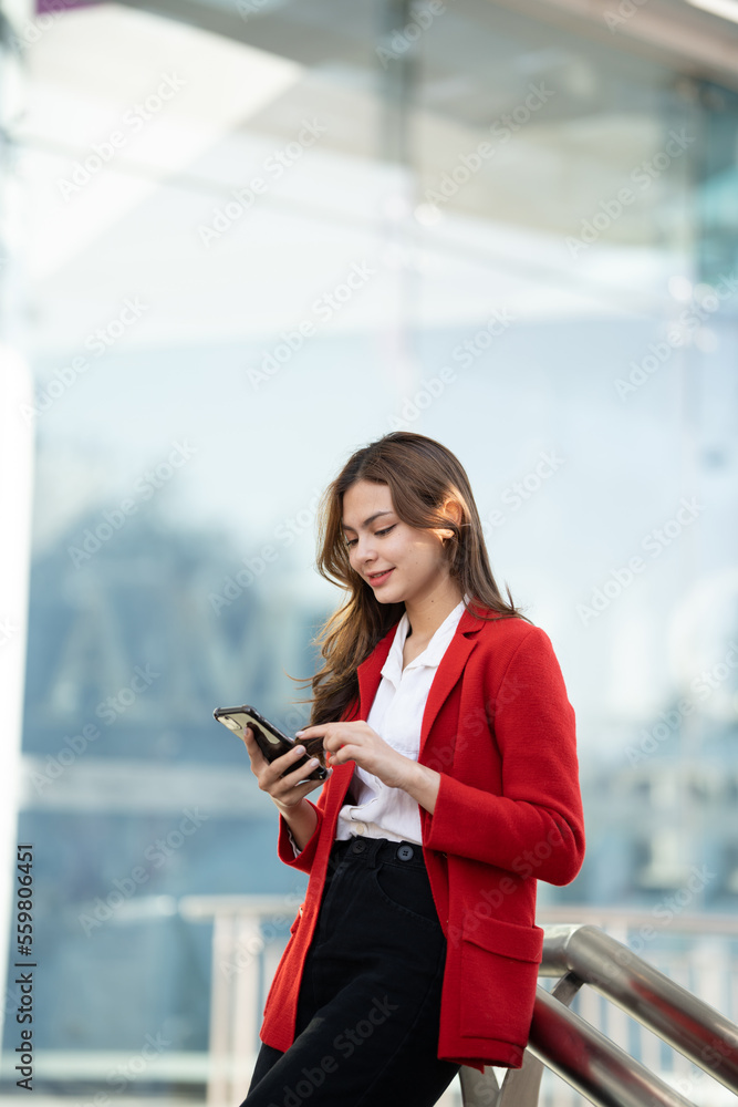 Young asian businesswoman using smart phone in office..