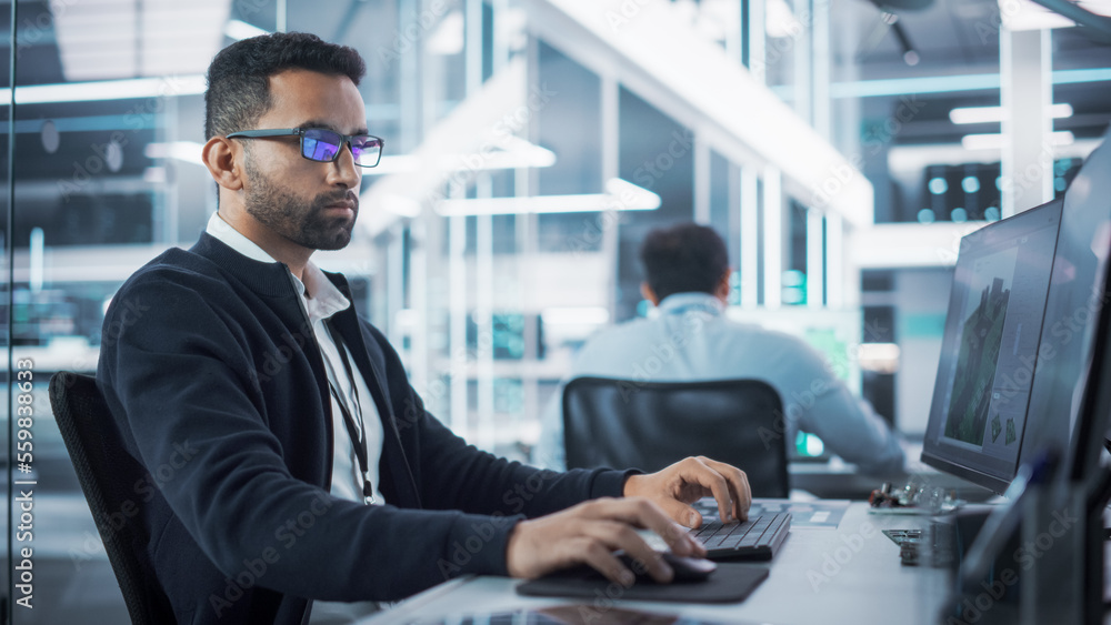 Portrait of Multiethnic Industrial Engineer Developing 3D Model of a Circuit Motherboard on Computer