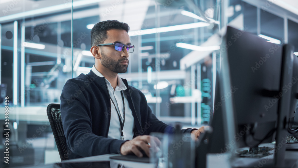 Portrait of Multiethnic Industrial Engineer Developing 3D Model of a Circuit Motherboard on Computer