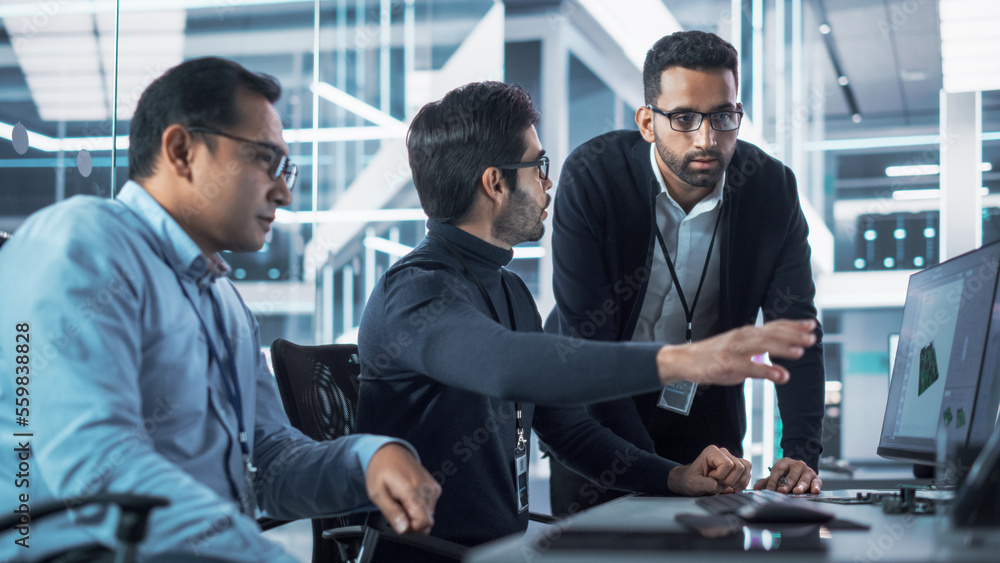 Team of Three Industrial Design Agency Specialists Discussing a 3D Circuit Board Model Created on a 