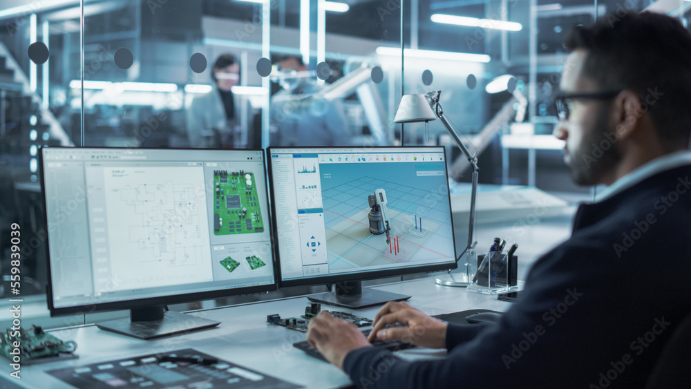 Portrait of a Young Hispanic Industrial Engineer Developing 3D Model of a Circuit Motherboard on Com