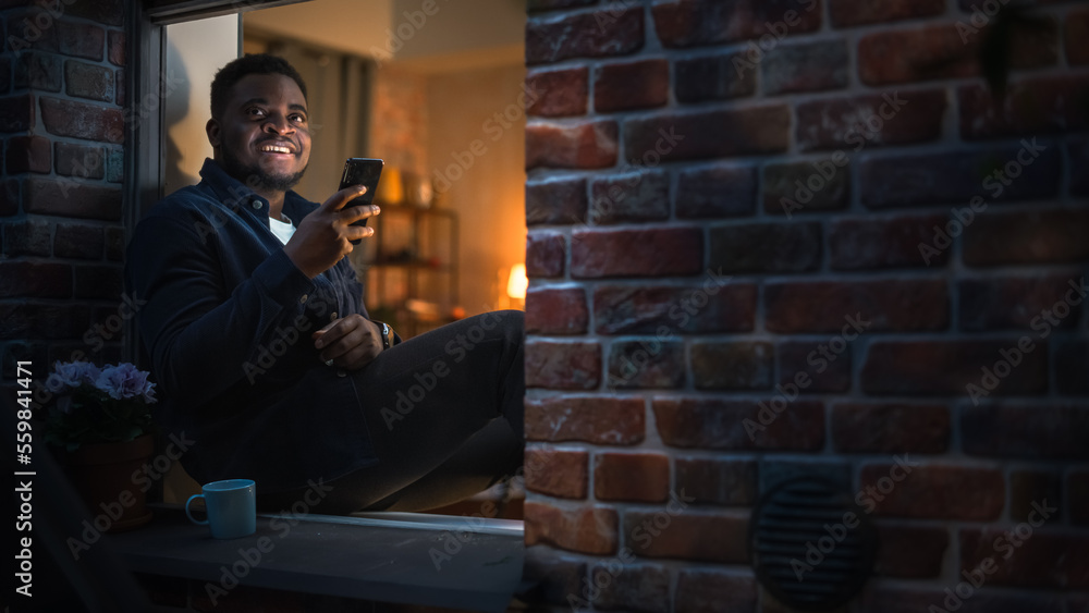 Happy Black Man Using Smartphone to Browse Funny Online Content or Chat with Friends on Social Media