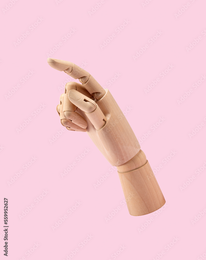 Wooden mannequin hand on pink background. Wooden hand with posture of number 1.