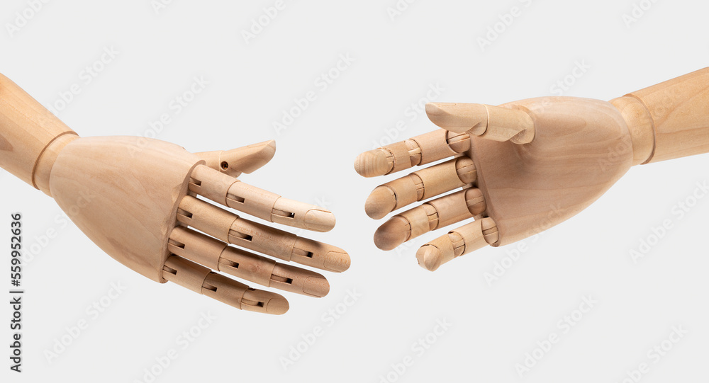 Two wooden mannequin hands on white background. Shaking hands.