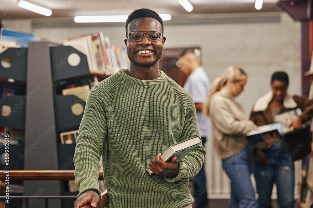 Black man, book and portrait in library with smile, research and studying at college for education. 