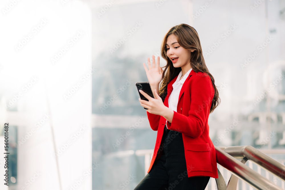 Buinesswoman concept a female manager attending video conference and holding tablet, smatrphone and 