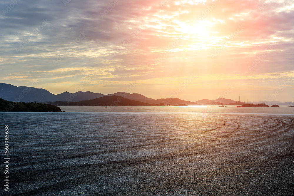 Empty asphalt road by the sea. Road and mountain with sea at sunset.