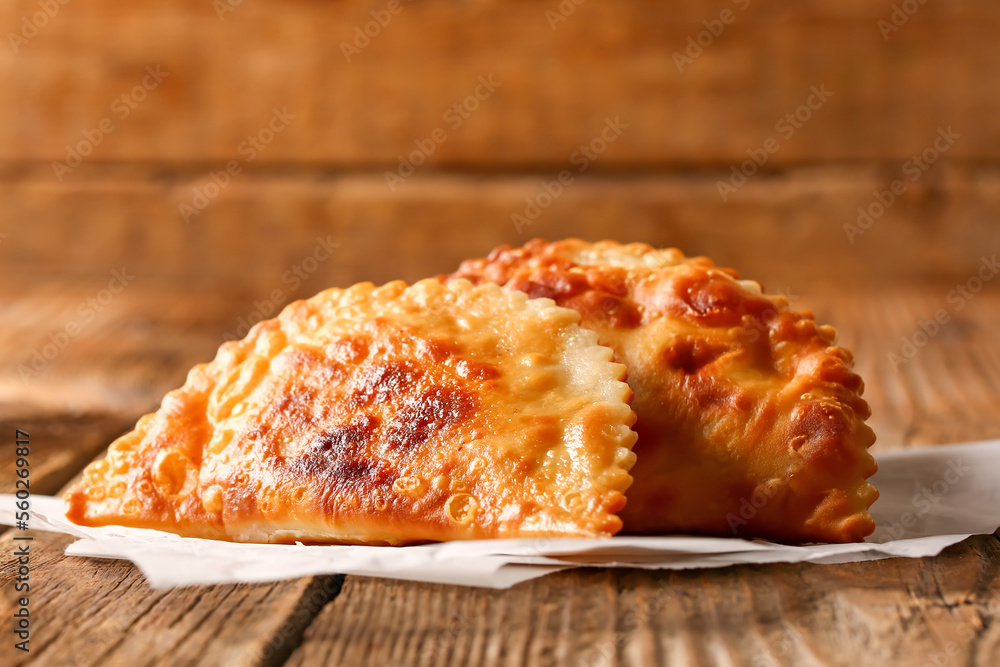 Tasty chebureks on wooden background, closeup