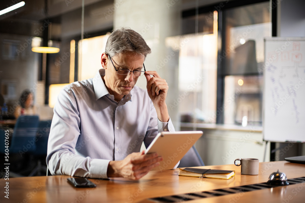 Portrait of businessman in office. Man using digital tablet. Businessman having video call