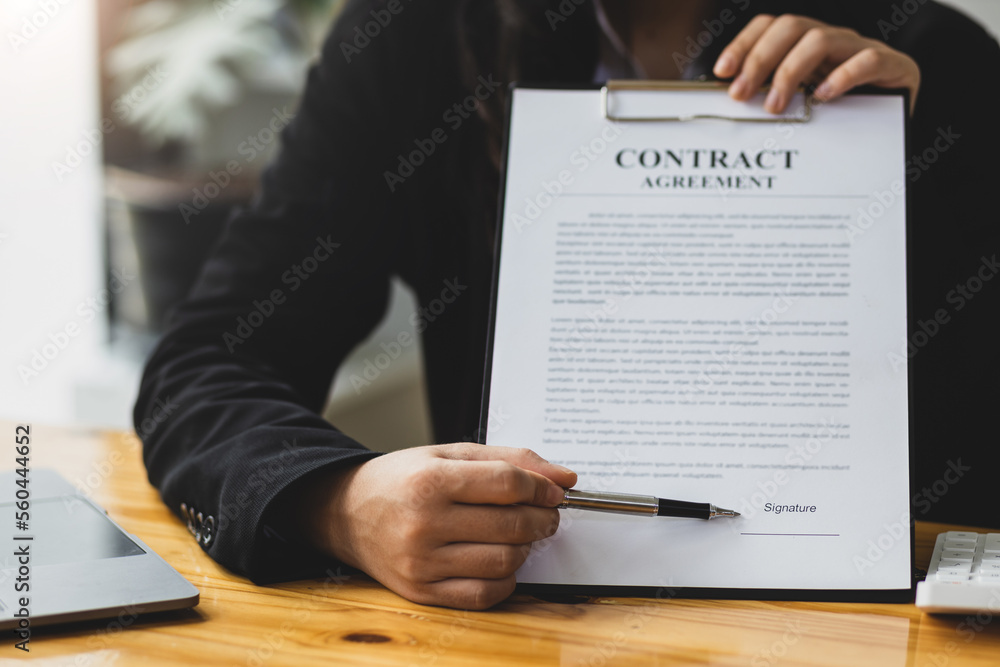 Businesswoman, real estate agent holding contract documents explaining legal agreement, mortgage, re