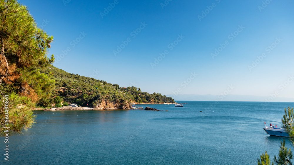 Beautiful panoramic view of the Black Sea with yachts and islands in the background. Rocky coast wit