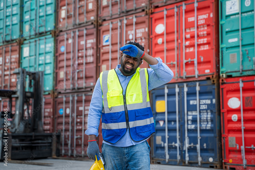 Engineer or foreman checking about shipping of container box in warehouse stock yard.