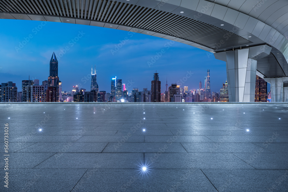 Asphalt road and bridge with city skyline at night in Shanghai, China.