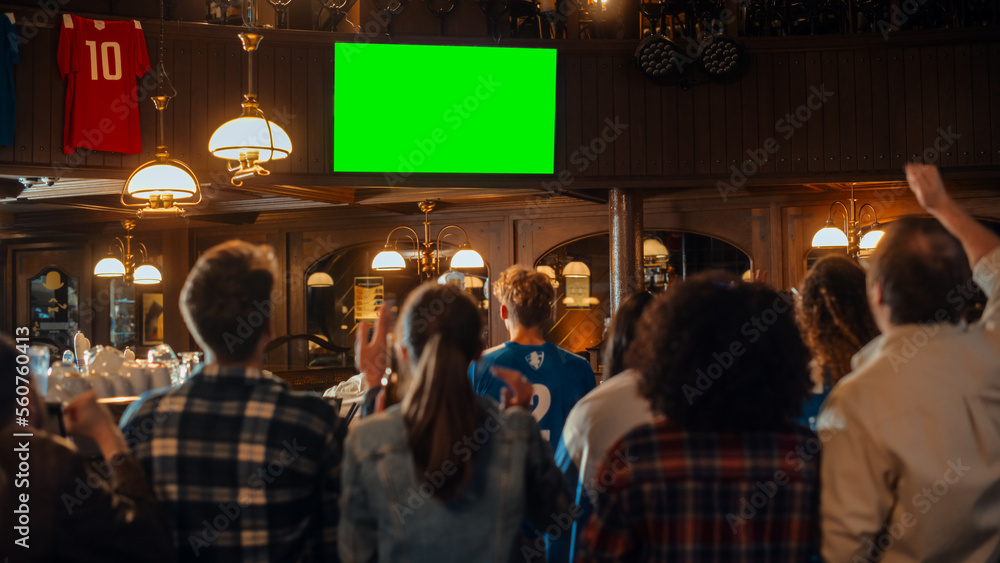 Group of Multicultural Friends Watching a Live Sports Match on TV with Green Screen Display in a Bar