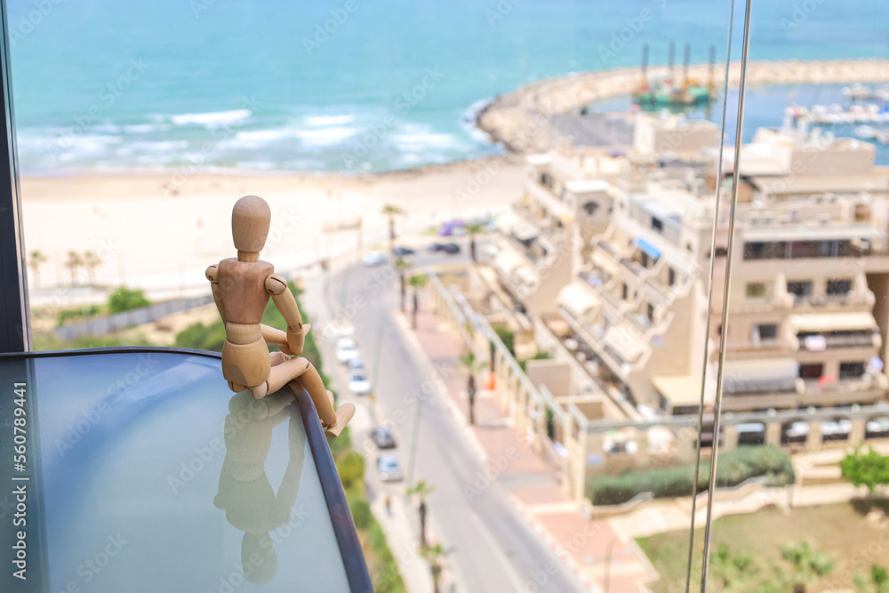 Wooden mannequin on balcony, closeup