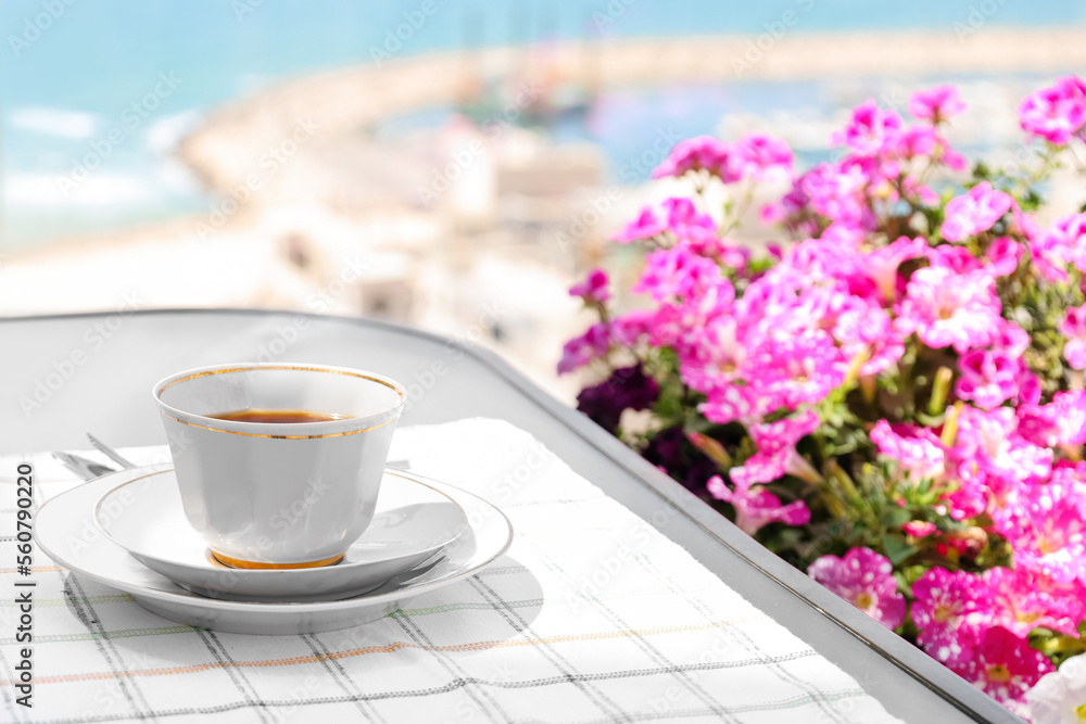 Cup of coffee on table near window, closeup