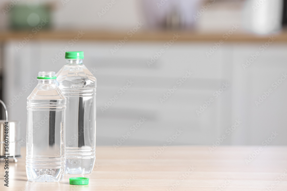 Bottles of water on table in kitchen, closeup