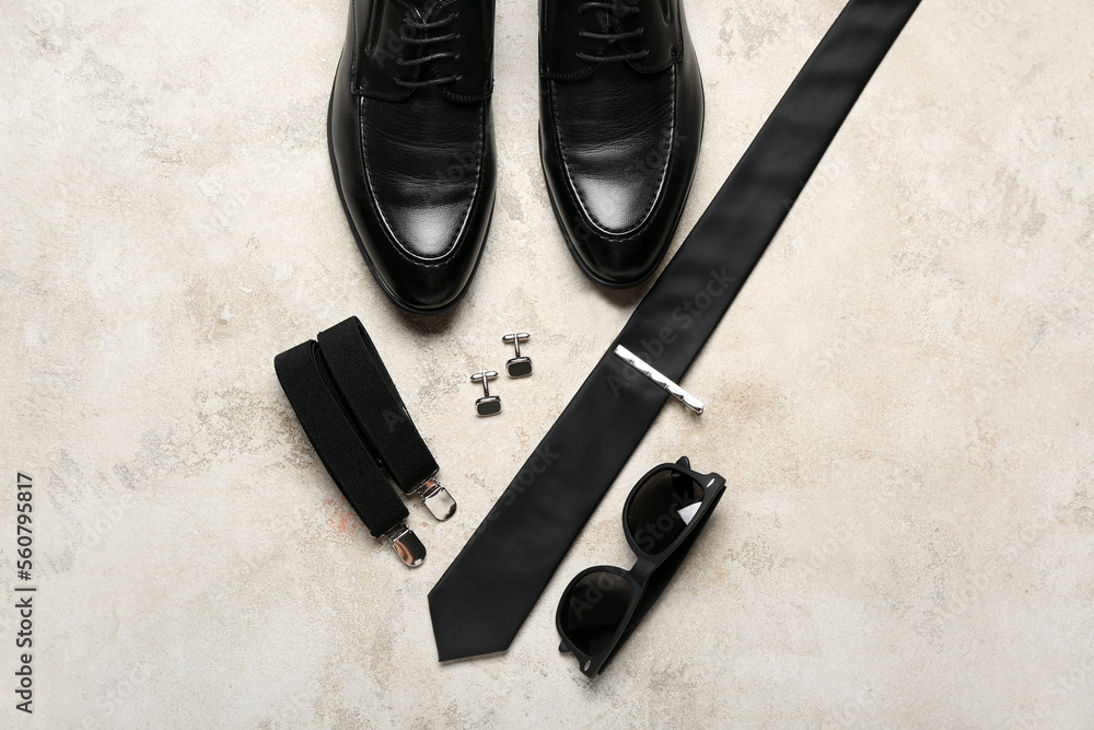 Male shoes and stylish accessories on light background