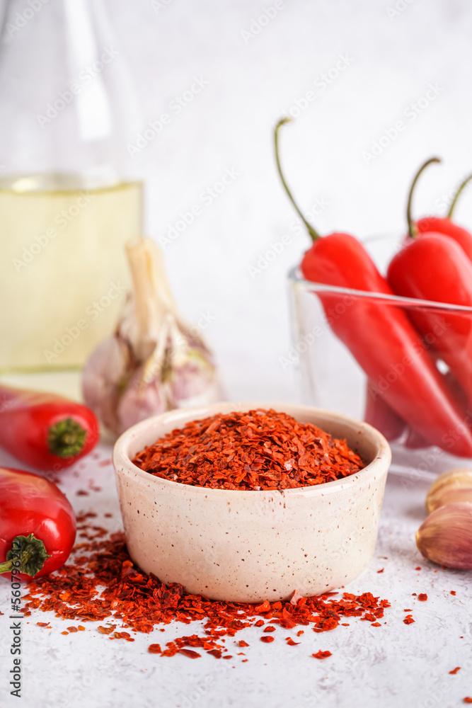 Bowl of chipotle chili flakes on light background