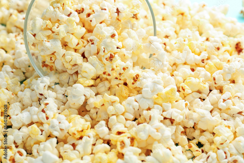 Overturned bowl of tasty popcorn, closeup