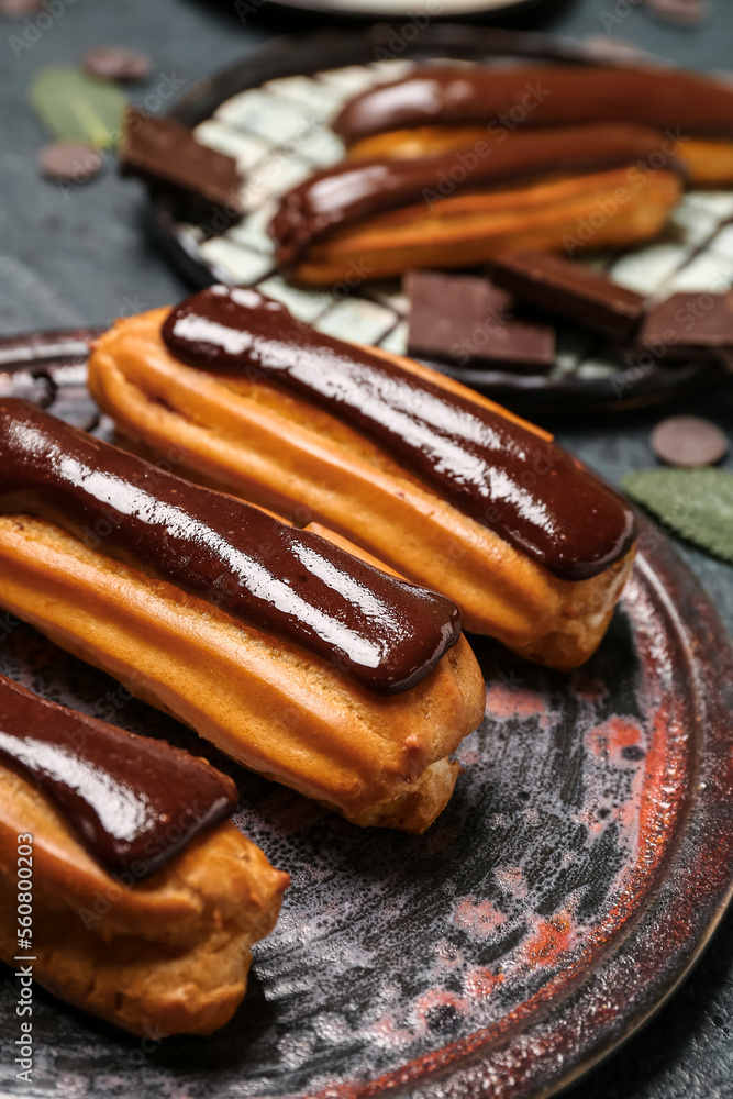 Plate with chocolate eclairs, closeup