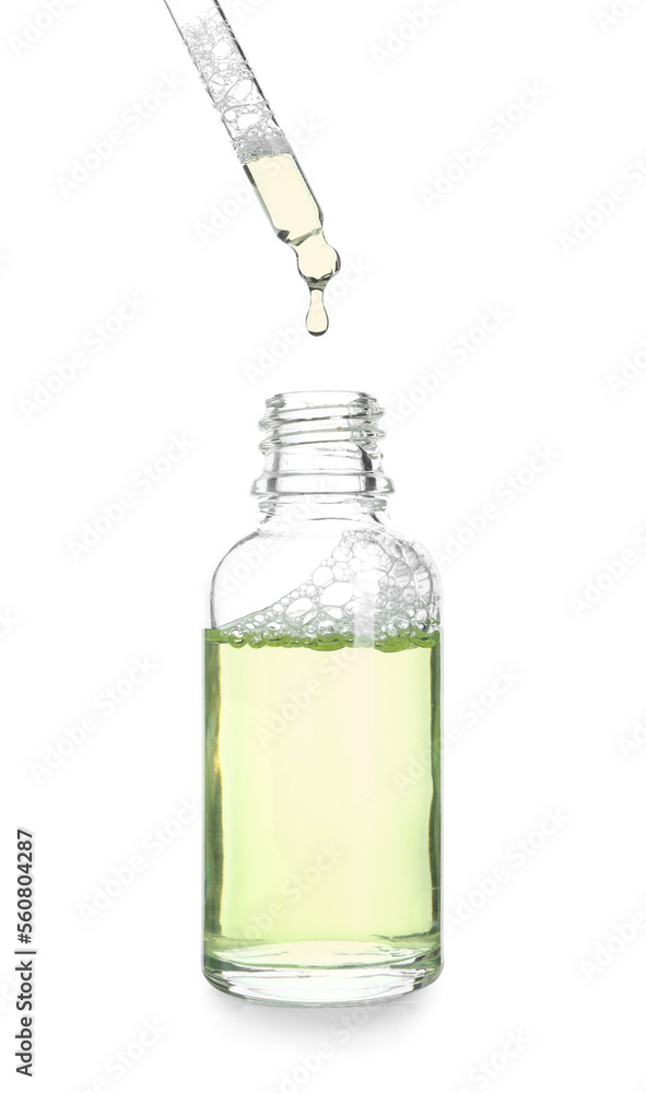 Dripping of natural serum into bottle on white background