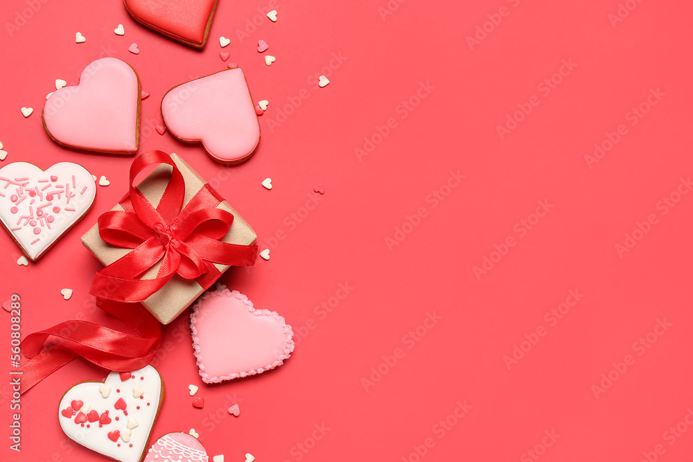 Composition with sweet heart shaped cookies, gift box and sprinkles on red background. Valentines D