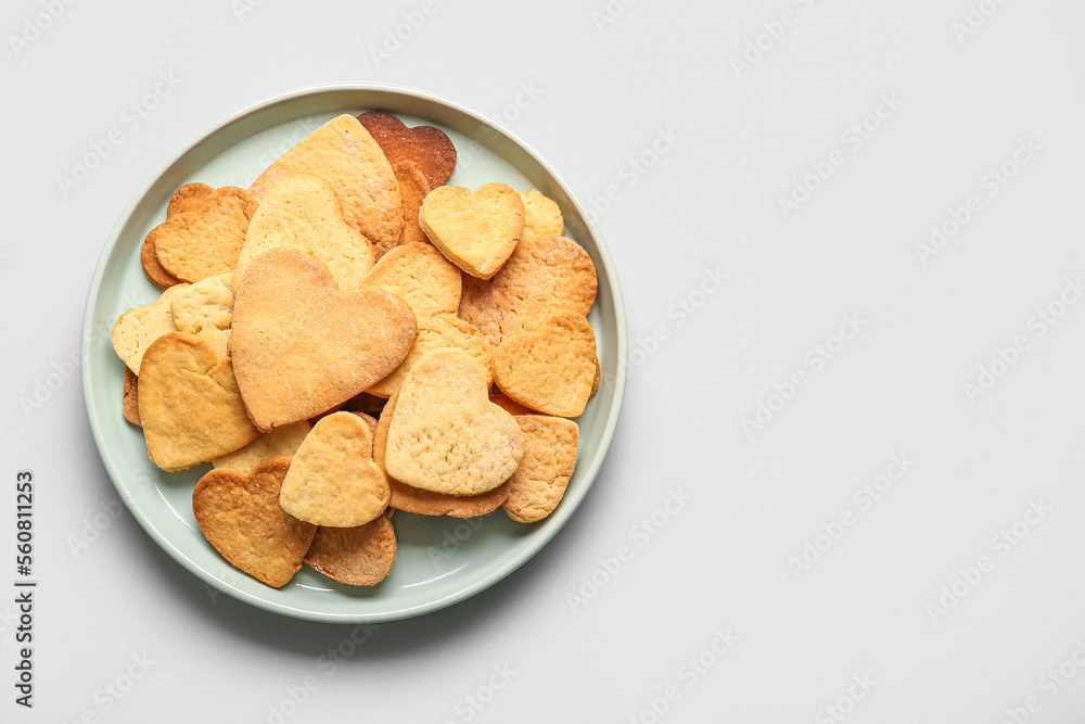 Plate with sweet heart shaped cookies on light background. Valentines Day celebration