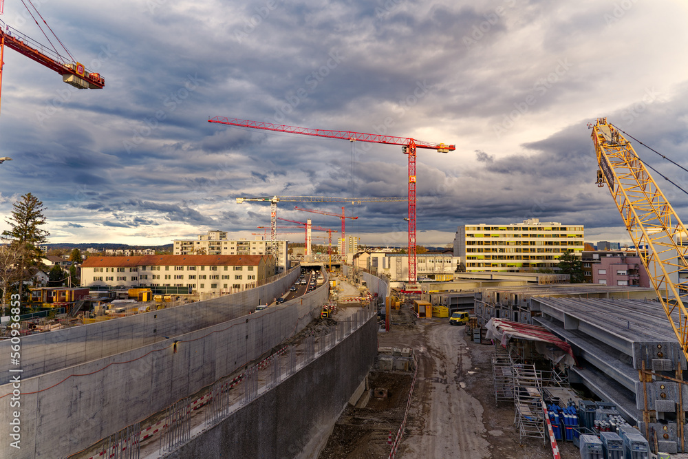 Highway enclosure construction site with stapled girders and mobile crane at City of Zürich district