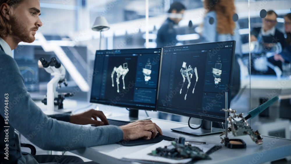 Robotics Engineer Working on Programming a Robot Dog on Desktop Computer. Young Team of Internationa