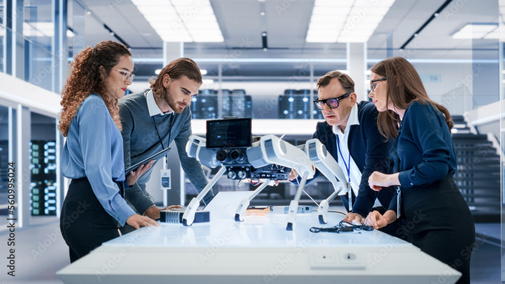 Portrait of a Young Team of Multicultural Engineers Use Computers, Insert a Circuit Board, Analyze a