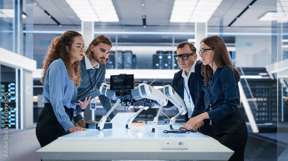 Portrait of a Young Team of Multicultural Engineers Use Computers, Insert a Circuit Board, Analyze a