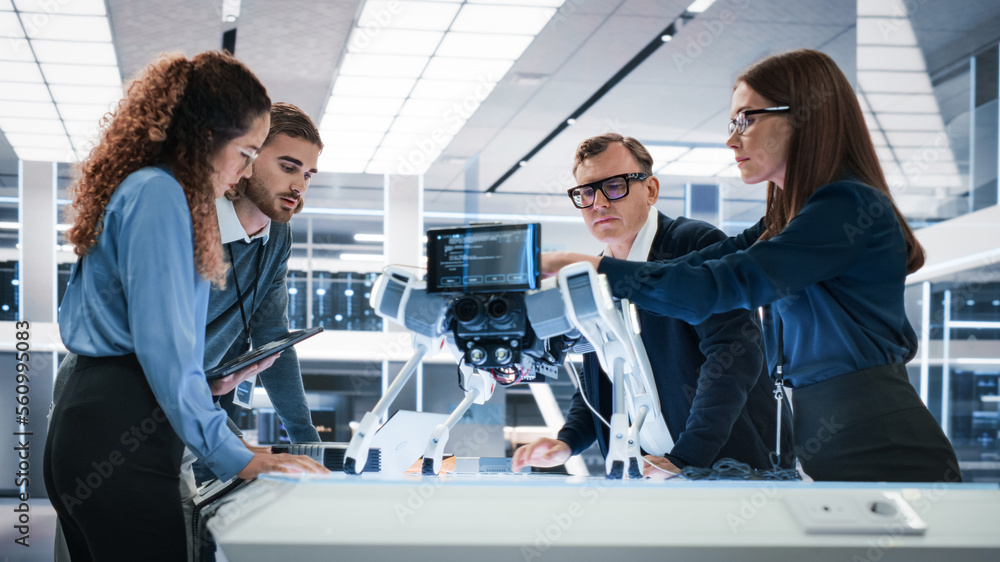 Portrait of a Young Team of Multicultural Engineers Use Computers, Connect Microchips, Analyze and D