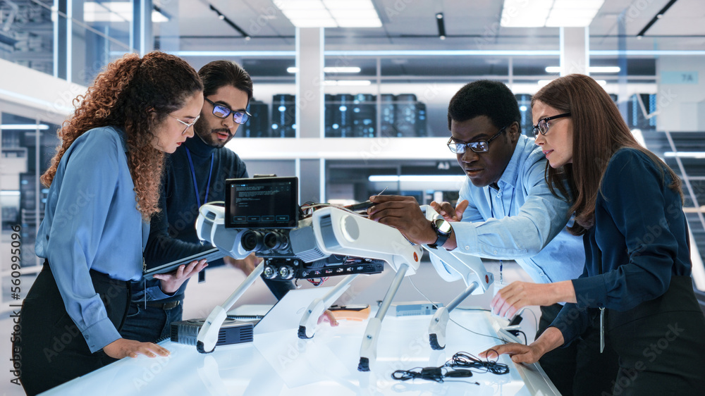 Portrait of a Young Team of Multicultural Engineers Use Computers, Insert a Circuit Board, Analyze a