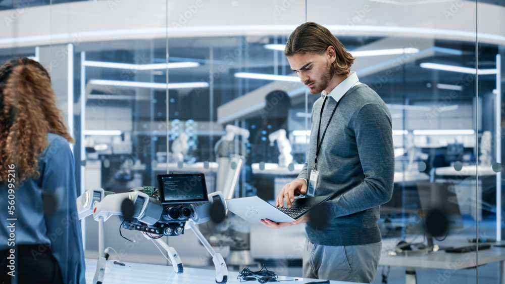 Young System Administrator Checking Online Internet Connectivity with a Prototype AI Robot Machine. 