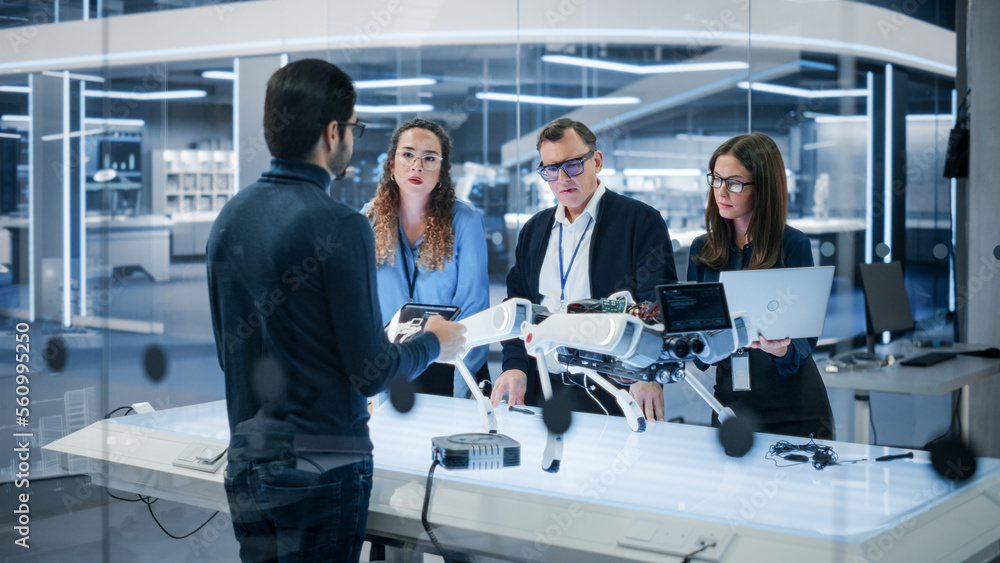 Diverse Team of Industrial Robotics Specialists Gathered Around a Table With a Mobile Robot. Scienti