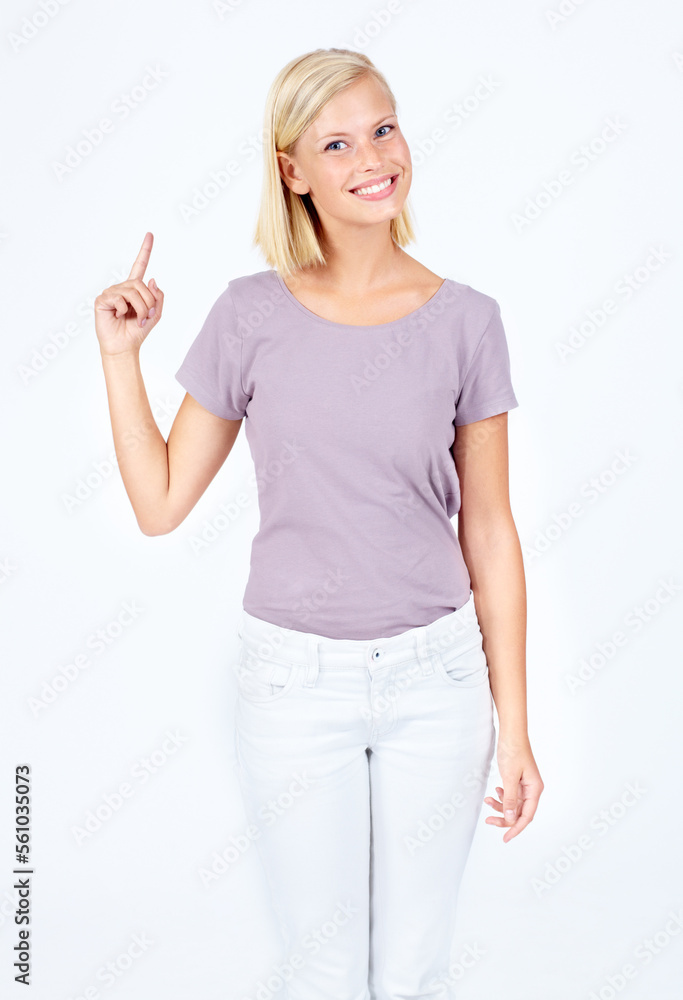 Portrait, point and mockup with a woman in studio on a white background pointing to blank product pl