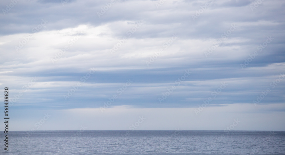 Above the sea blue sky with white clouds