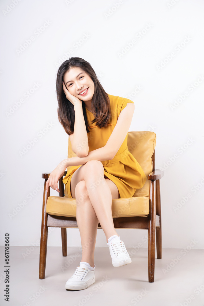 Image of young Asian woman sitting on chair