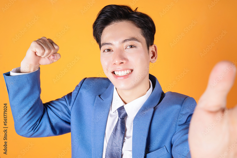 Photo of young Asian business man on background